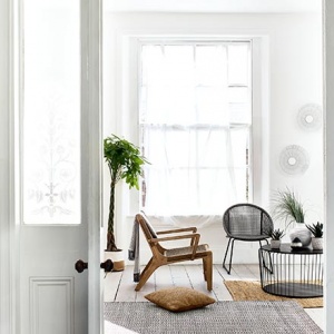 Sneak view of a minimal Scandi looking sitting set in a bright white room. I just love both armchairs with their textured feel and the black round coffee table in front of them. Image by Debenhams.