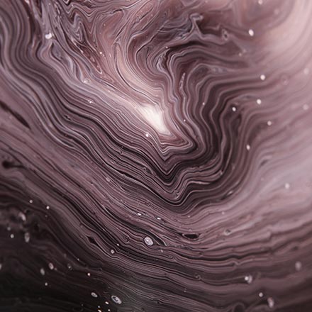 Close up image of an experimental painting with thin rings of white and black paints. Image by Lurm on Unsplash.