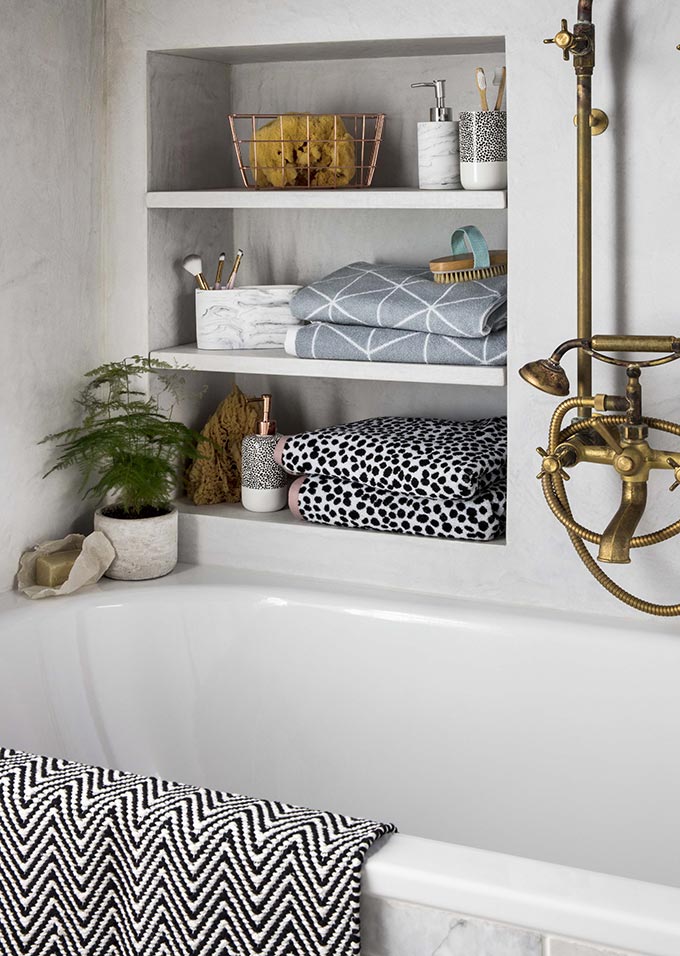Zen bathroom ideas: I just love shelves in wall inserts with towels and decor next to a bathtub. So cozy! Image by George Home.