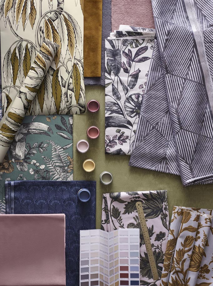 A flatlay with tropical leaves pattern wallpaper, textiles and color samples. Image by John Lewis.