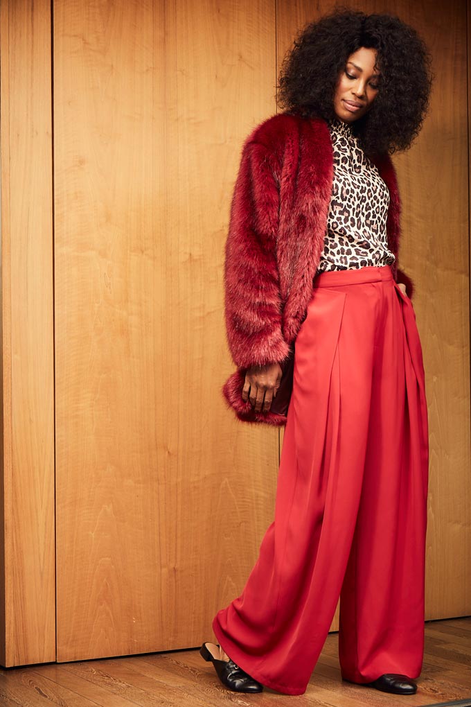 A leopard top with red wide leg pants and a burgundy faux fur jacket surely make an eye catching fashion statement. Image by JD Williams.