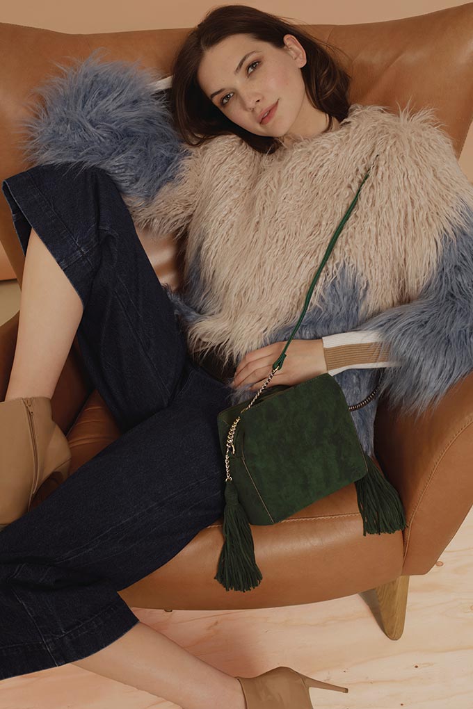 I love this color blocked shaggy faux fur jacket paired with navy blue denim pants and a green crossbody bag. Image by New Look.