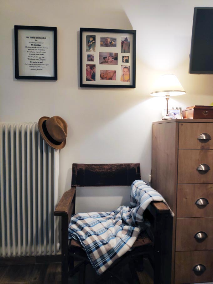 A vignette of Velvet's bedroom with two images on the wall, a director's leather chair and part of my dresser.