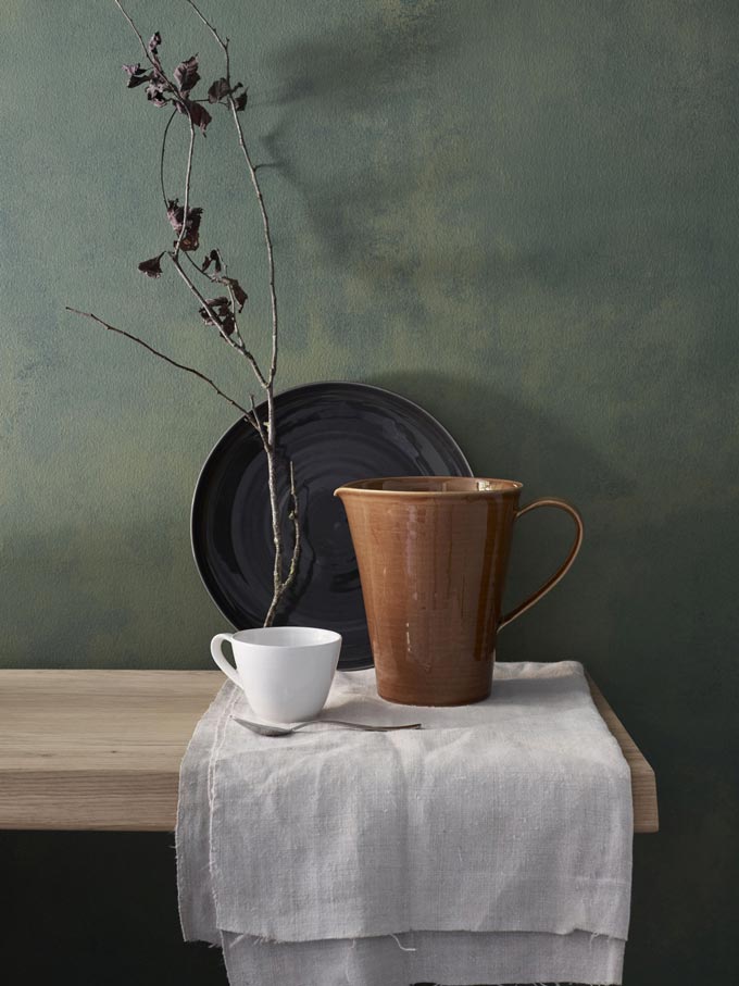 Ceramics: a black platter, a jug and a mug on a sideboard. Such simplicity yet looking so elegant. Image by John Lewis.