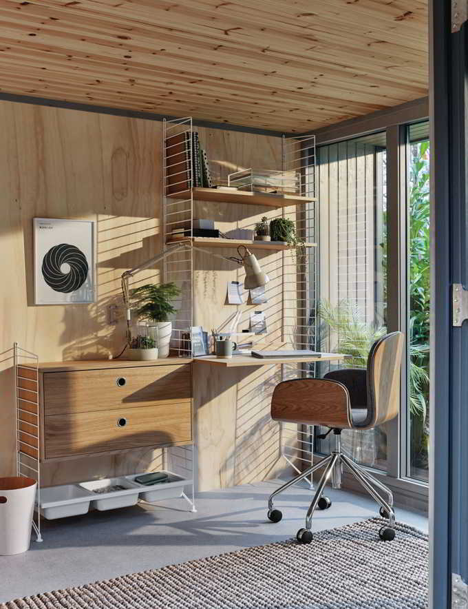 A Scandi inspired home office with a shelving unit by a window door. Image by John Lewis.