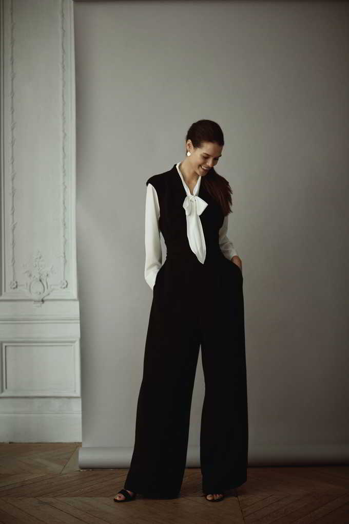 Now this is one of my favorite combos. A white shirt with a black sleeveless vested top and black wide leg pants. So stylish. Image by Matalan.