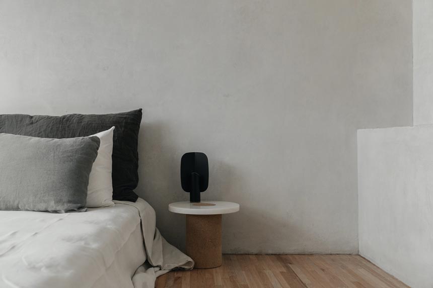 Designed for Frama by Nicholai Wiig-Hansen, the Sintra Table is a stunning showpiece that embodies the unification of opposites - marble against cork. Here seen next to a minimal contemporary bed. Image by Nest.co.uk.