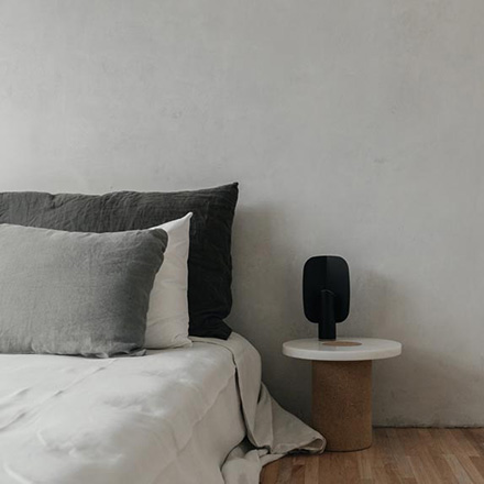 Designed for Frama by Nicholai Wiig-Hansen, the Sintra Table is a stunning showpiece that embodies the unification of opposites - marble against cork. Here seen next to a minimal contemporary bed. Image by Nest.co.uk.