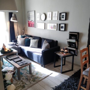 View of Timo's small living room with a black sofa and an art gallery wall.View of Timo's small living room with a black sofa and an art gallery wall.