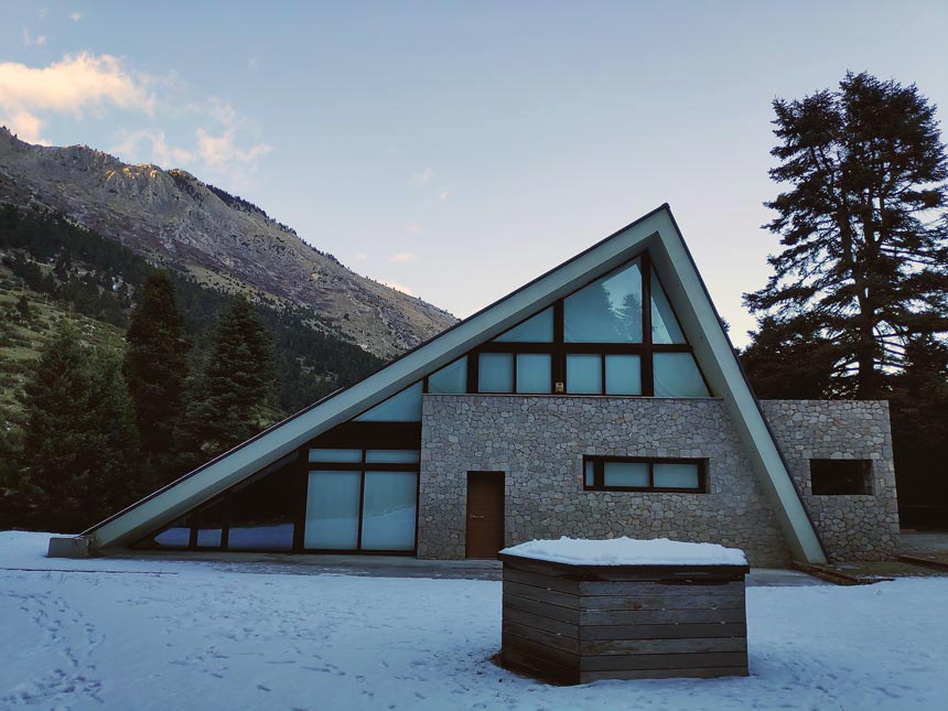 View of the front facade of a stunning chalet in Greece.