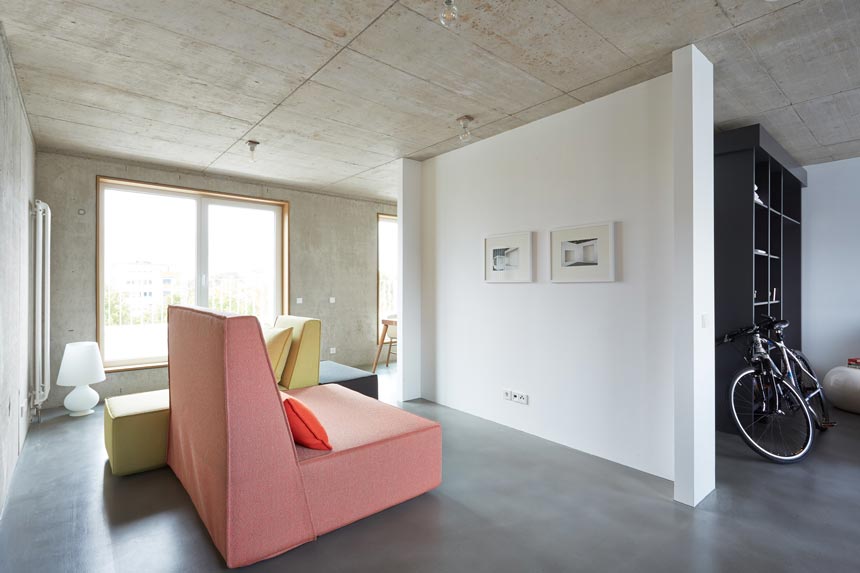 Cement decor ideas: Another view on the inside of a space in the Concrete Apartments in Köln. The Cubit modular sofas add warmth and comfort to the space. Image by Cubit.