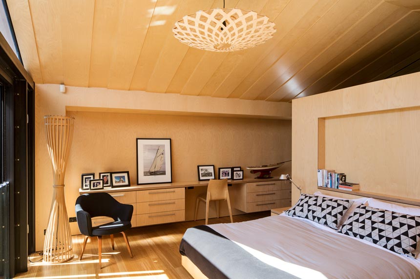 A beautiful bedroom with a David Thubridge pendant lighting, lots of light wood accents. Image by David Thubridge.