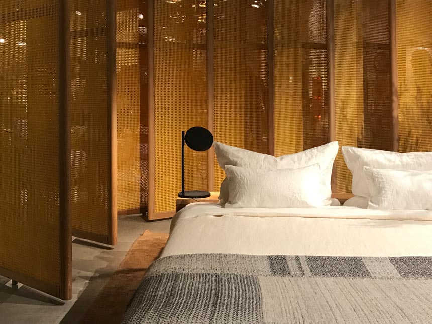 View of the bedroom area from "Das Haus" stand in imm Cologne 2019 fair. Note the mustard cane rotating partitions.