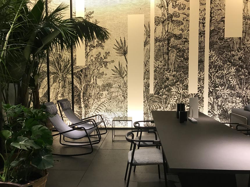 Partial view of a living space with a mural as an accent wall from the stand of Livingdivani at imm Cologne 2019.