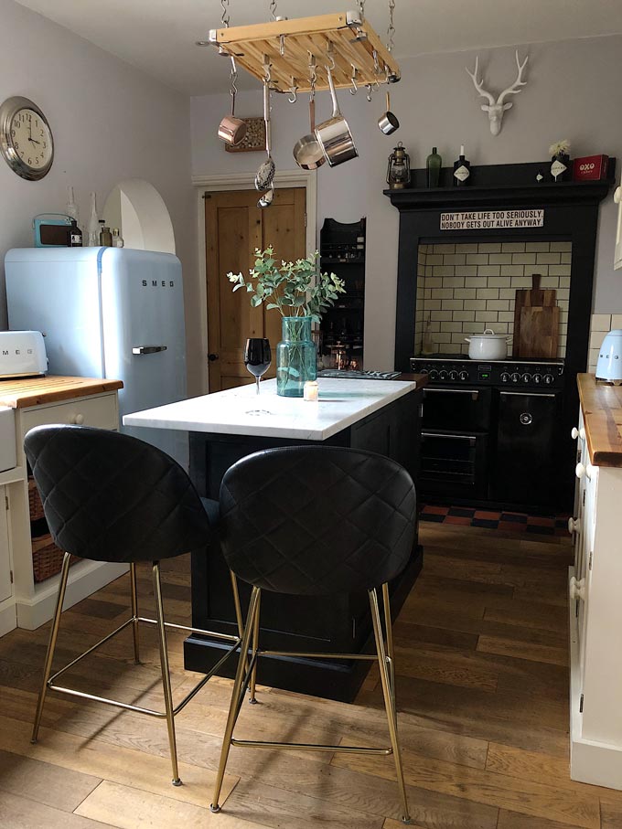 A touch of black in a kitchen goes a long way. The stove, the island and those beautiful bar stools create a catching center axis across this kitchen turning up its sophistication level. I love the Heather barstools with a sense of art deco because of the touch of glamour. Image by Cult Furniture.