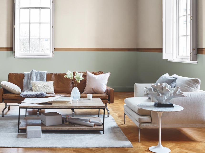 A bright, contemporary living room with caramel accents and neutral tones. Image by Dulux.