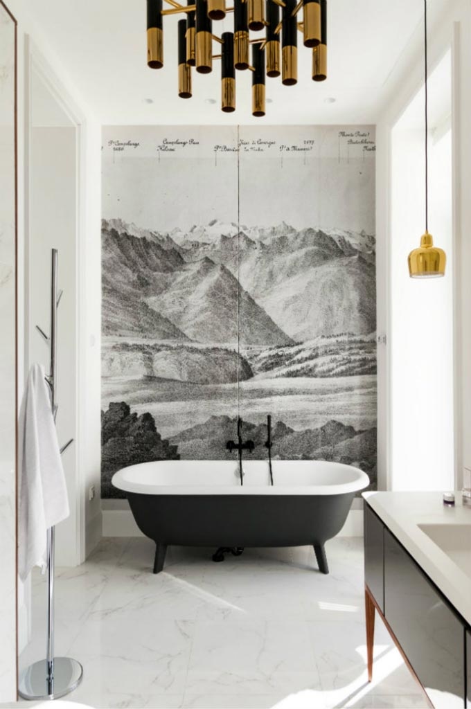 A classic black and white bathroom with an accent wallpapered wall, a free standing tub, a golden chandelier and black fittings. Do I need to say how gorgeous it all is? Image by DelightFULL.