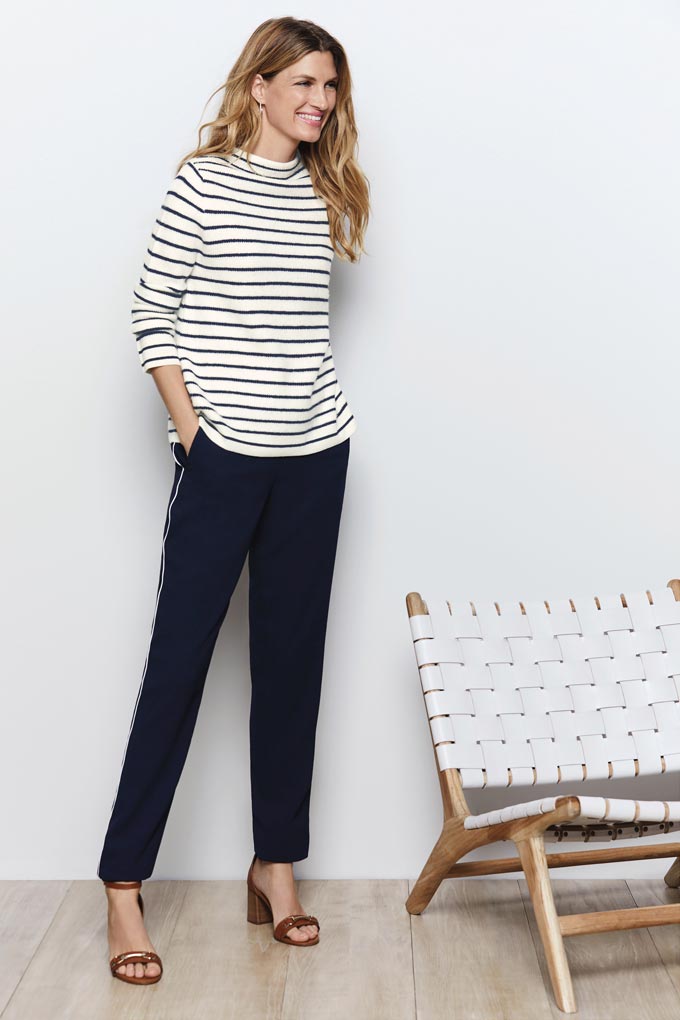A Breton top with a loose fit over slim black pants and high heel sandals is a timeless outfit. Image by Pure Collection.