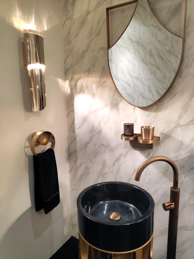 A luxurious bathroom installation with brassy taps and accessories from Maison Valentina at iSaloni2019 in Milan.
