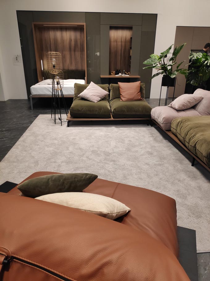 A beautiful space with multi-functional furniture from Tumidei at iSaloni 2019 in Milan in organic hues like deep olive green and rusty tones.
