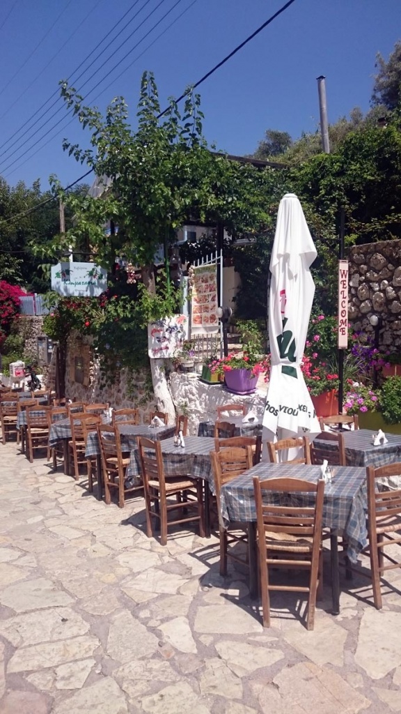 A traditional outdoor taverna setup at the seaside village of Agios Nikitas in Lefkada. Image by Velvet Karatzas.