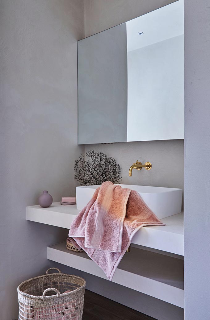 I love this minimal contemporary bathroom with a frameless mirror, a brass tap. Image by Christy.