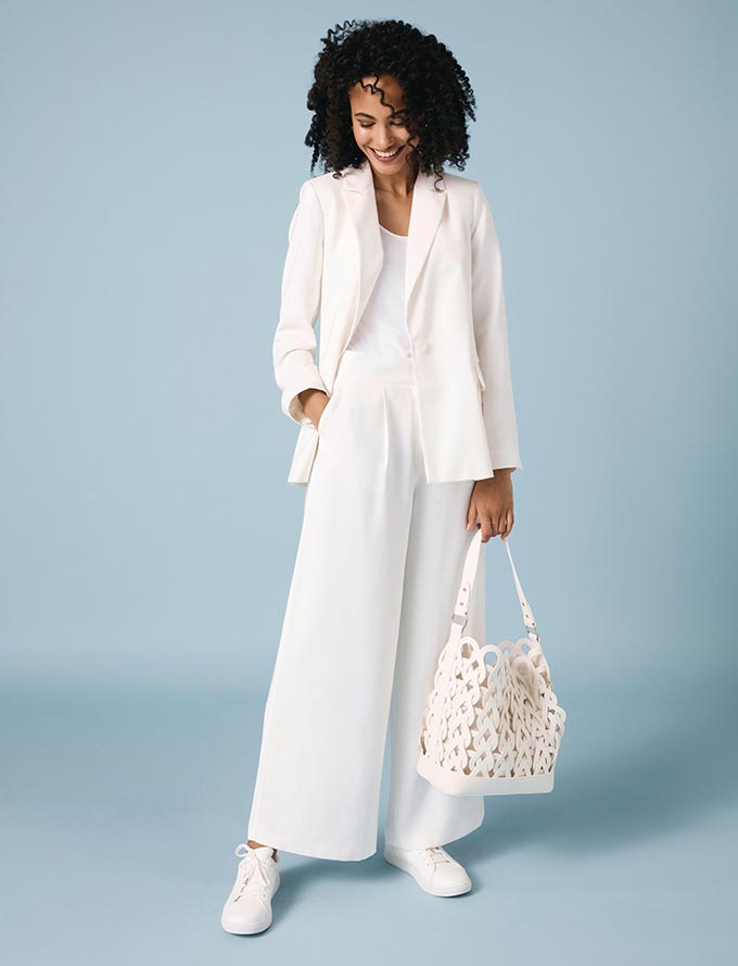 The all white outfit: blazer, top, wide leg pants, tote bag, trainers. Perfection! Image by Oasis.