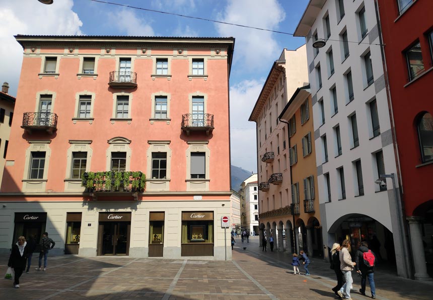 Colorful buildings within a pedestrian zone in the old town of Lugano.