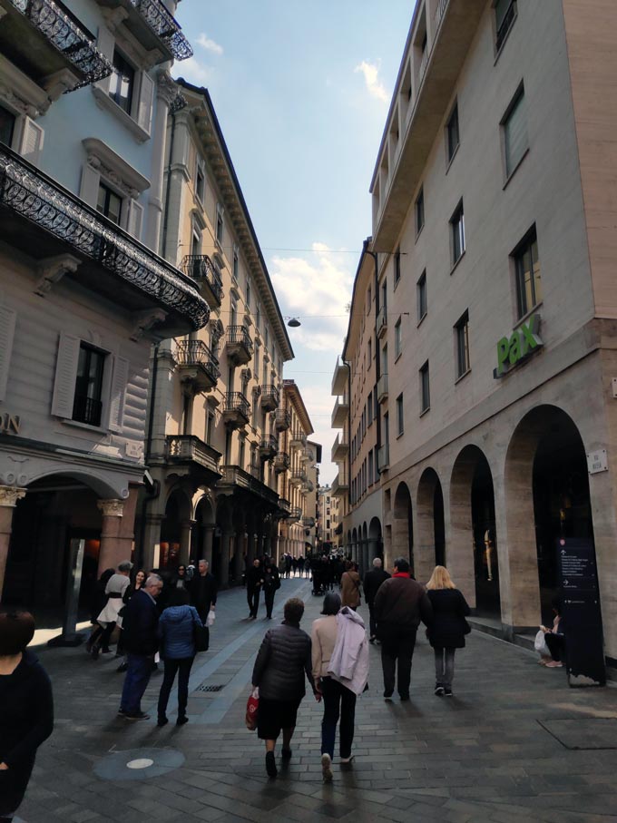 People walking along a pedestrian zone in the old town of Lugano.