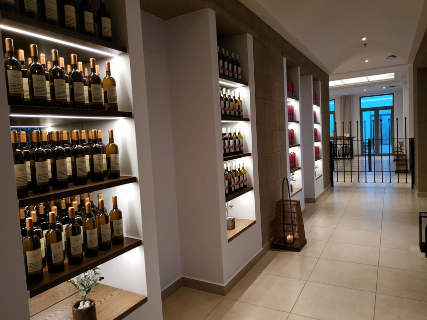 Partial view of a wall filled with wines on display at Grecotel Lux Me Rhodos.