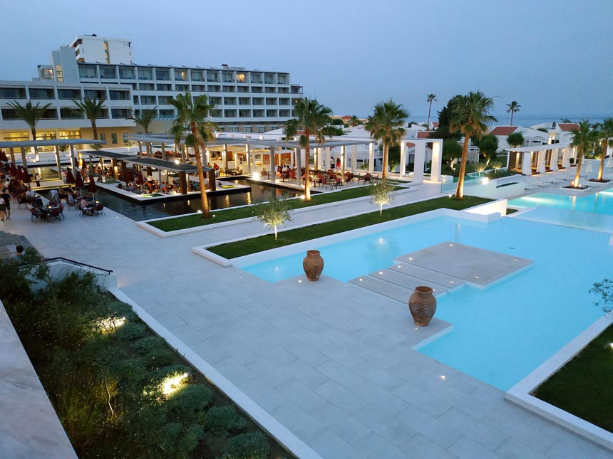 Partial view of the large pool and outdoor dining spaces of Grecotel Lux Me Rhodos.