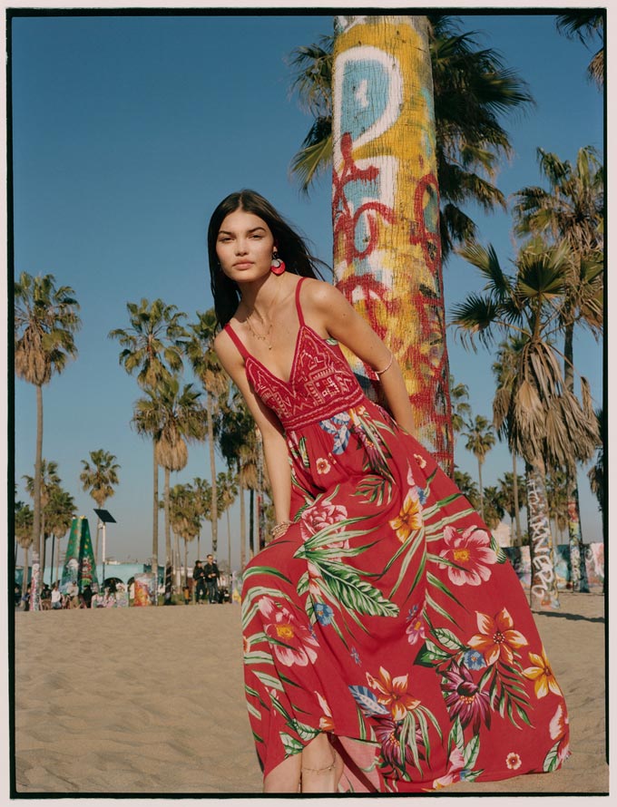 Print and pattern fashion: A red maxi summer dress with a large flower print has a bold, modern and playful vibe to it. Image by Accessorize.