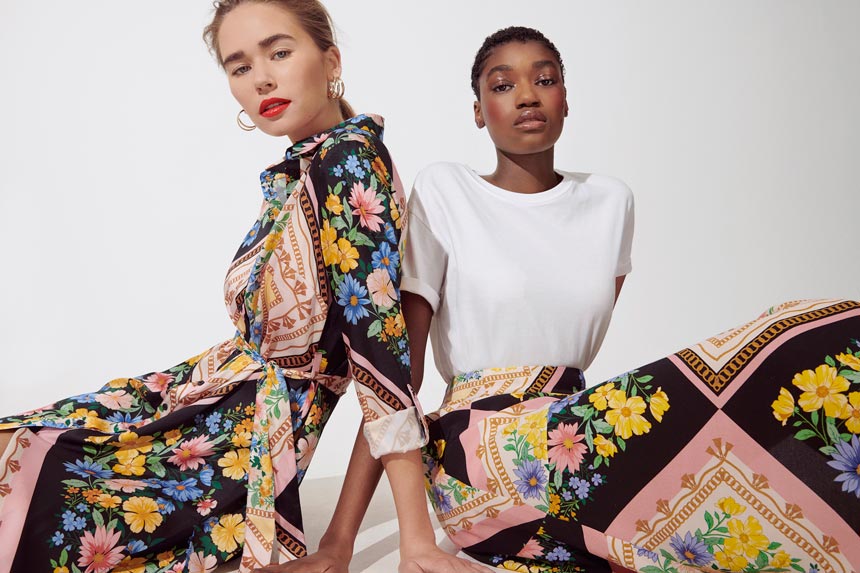 Love the boldness of this print pattern. Two women wearing a bold print dress and a white top with the same print maxi skirt. Image by Miss Selfridge.