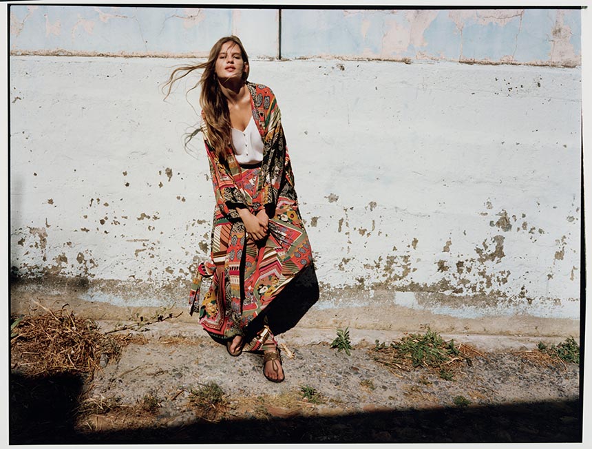 Love the boho vibe of this vibrant print pattern of the oversized shawl and matching maxi skirt paired with a white top. Image by Monsoon.