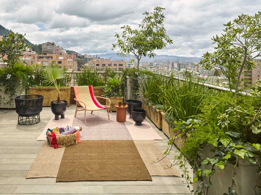 The maraca chair on top of the nobsa rug surrounded by barro ceramics situated on a roof terrace