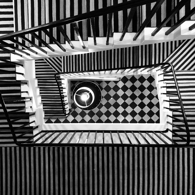 A striking stairwell seen from above because of the different striped patterns.