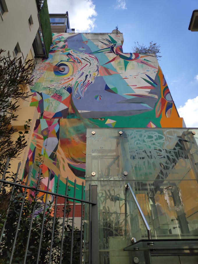 A building's facade with street art graffiti in the area of Monastiraki downtown Athens.