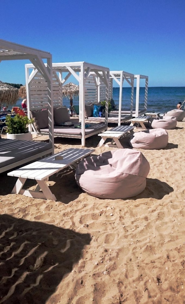 Gazebos at a sandy beach along the Athenian coastline.