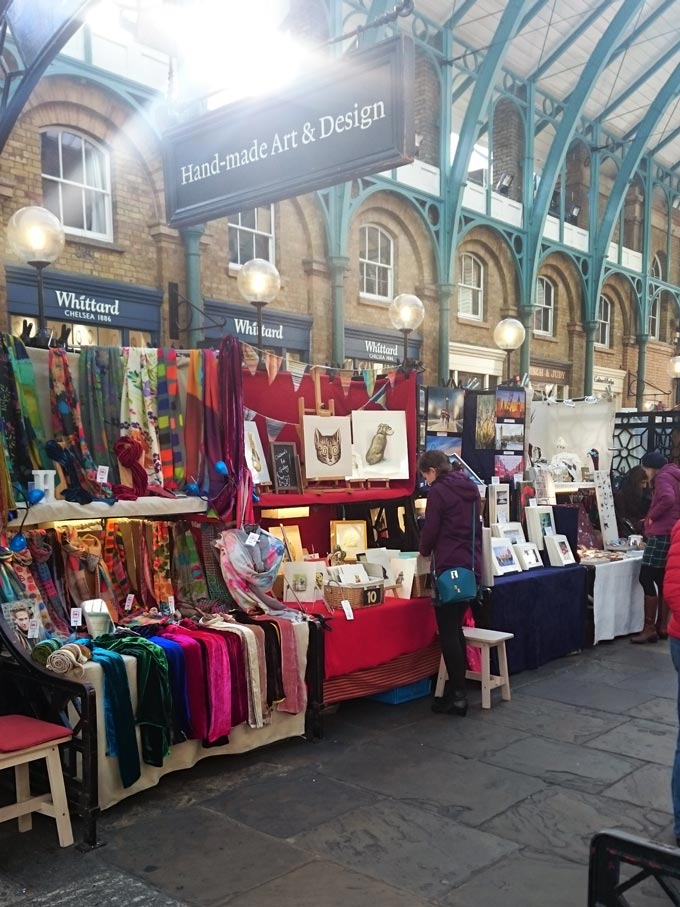 Booths with products for sale from artists and artisans in Covent Garden.