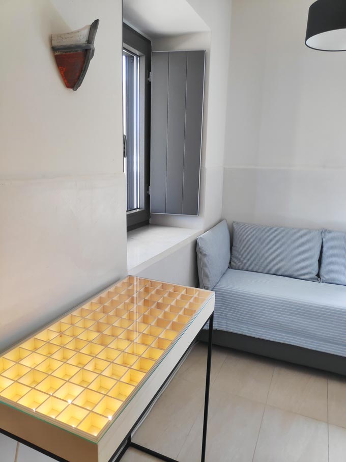 Cycladic minimal style: Detail view of a table that lights up for creating a perfect ambiance in a room of Hotel Emily in Syros.