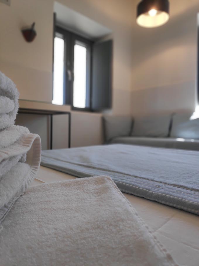 Partial view of the sofa bed of a triple bedroom at Hotel Emily in Syros.