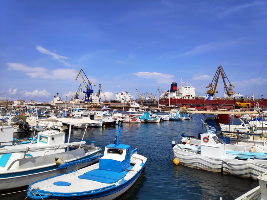 View of a marina in the foreground and the shipyard of Neorion in Syros in the background.