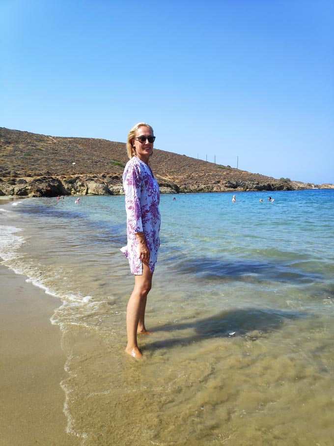 Velvet standing with her feet in the sea at Komito beach in Syros.