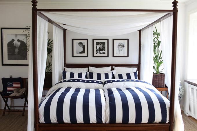 Decorating ideas with stripes: A bedroom with striped bedding and an overhead canopy has always a classic styled flair to it. Image via KSL Living.