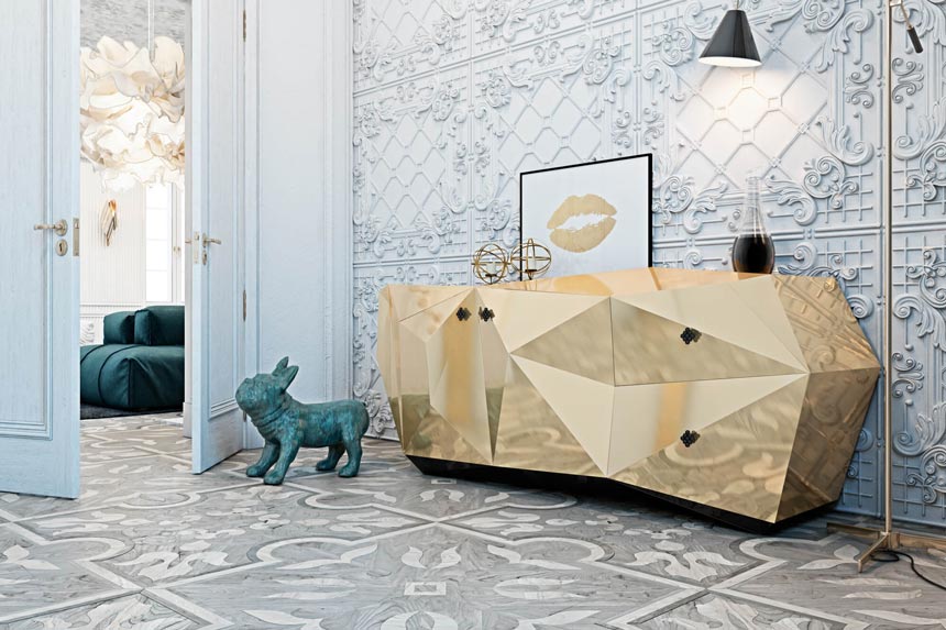 A stunning sideboard shaped like a gold diamond against a highly decorated accent wall from a design project by Diff studio.