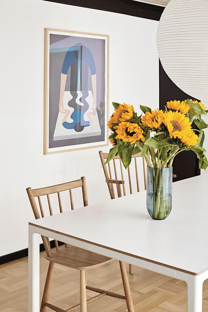 Upgrade an Airbnb listing: Use a vase with sunflowers. It is always a nice touch in any decor, especially on a white dining table like this. Image via Nest.co.uk.