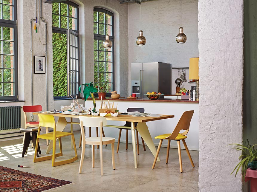Upgrade an Airbnb listing: Can't go wrong with a vibrant kitchen with pops of color and various designer chairs around a dining table that looks all so fresh. Image via Nest.co.uk.