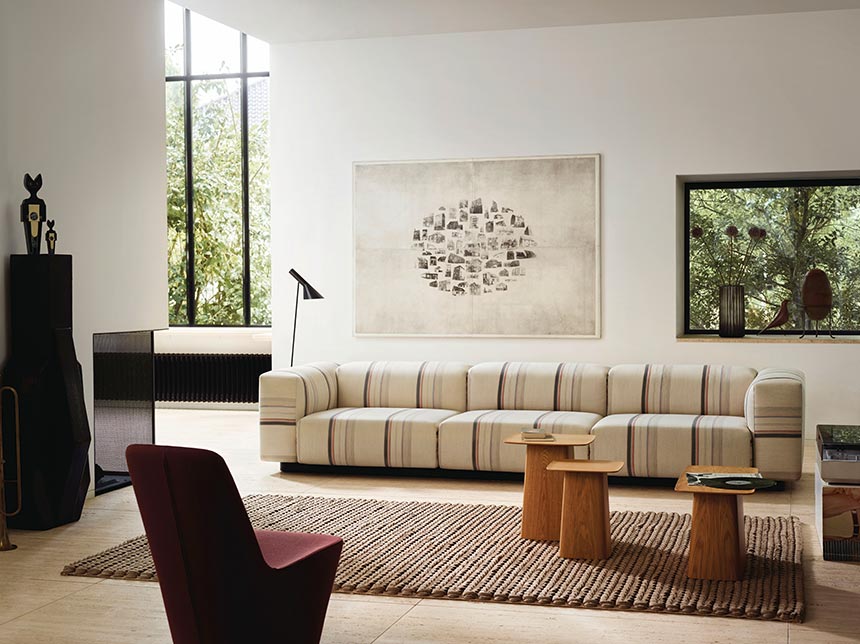 A neutral contemporary living room with a print pattern sofa. Image via Nest.co.uk.