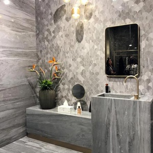 A marble bathroom installation from Atlas Concorde at the Cersaie 2019. Love the accent wall with the fishscale tile accent.