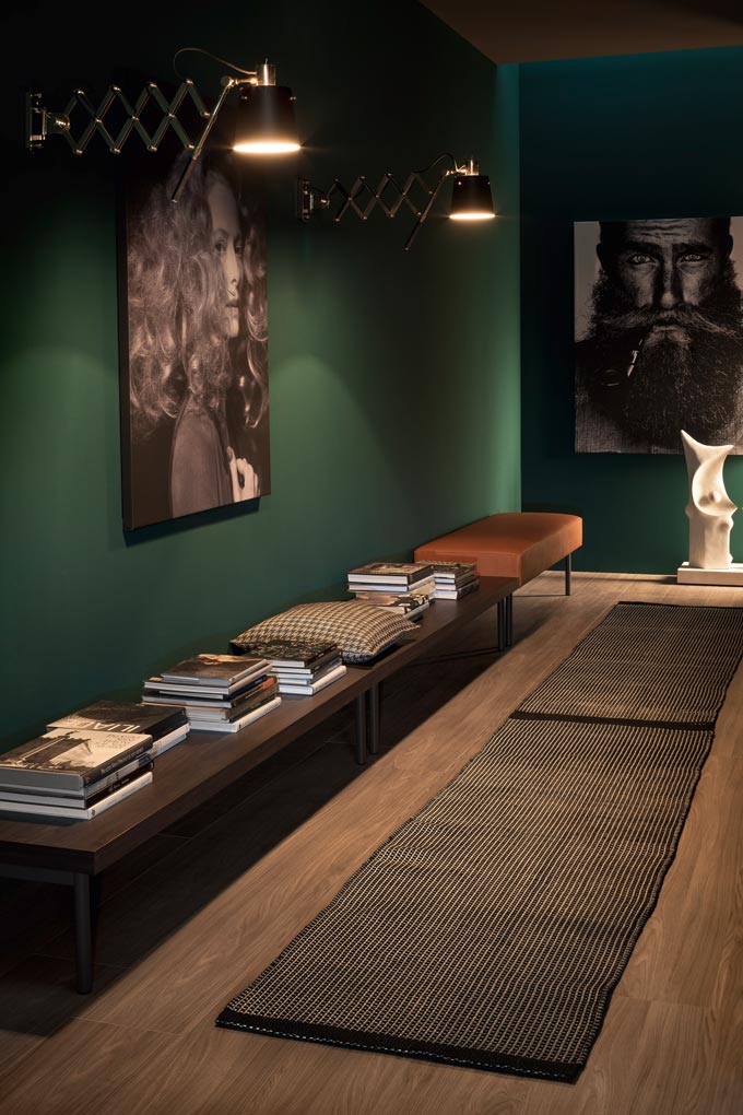 I love the mood of this corridor with its dark green wall and hardwood floor. Image via DelightFULL.